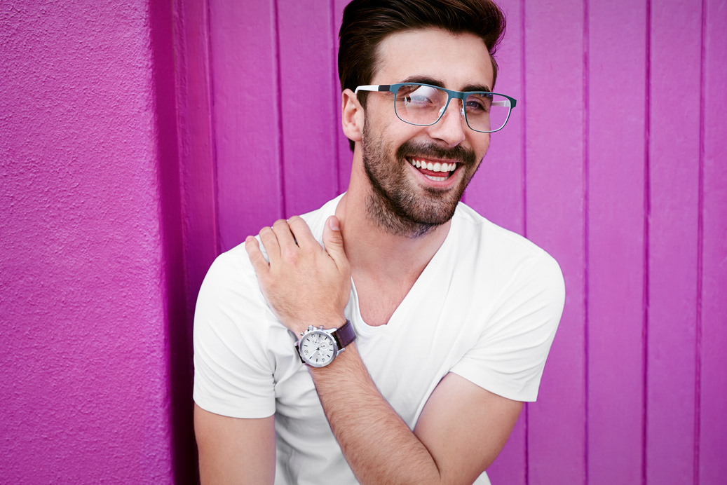 Laughing young guy in specs